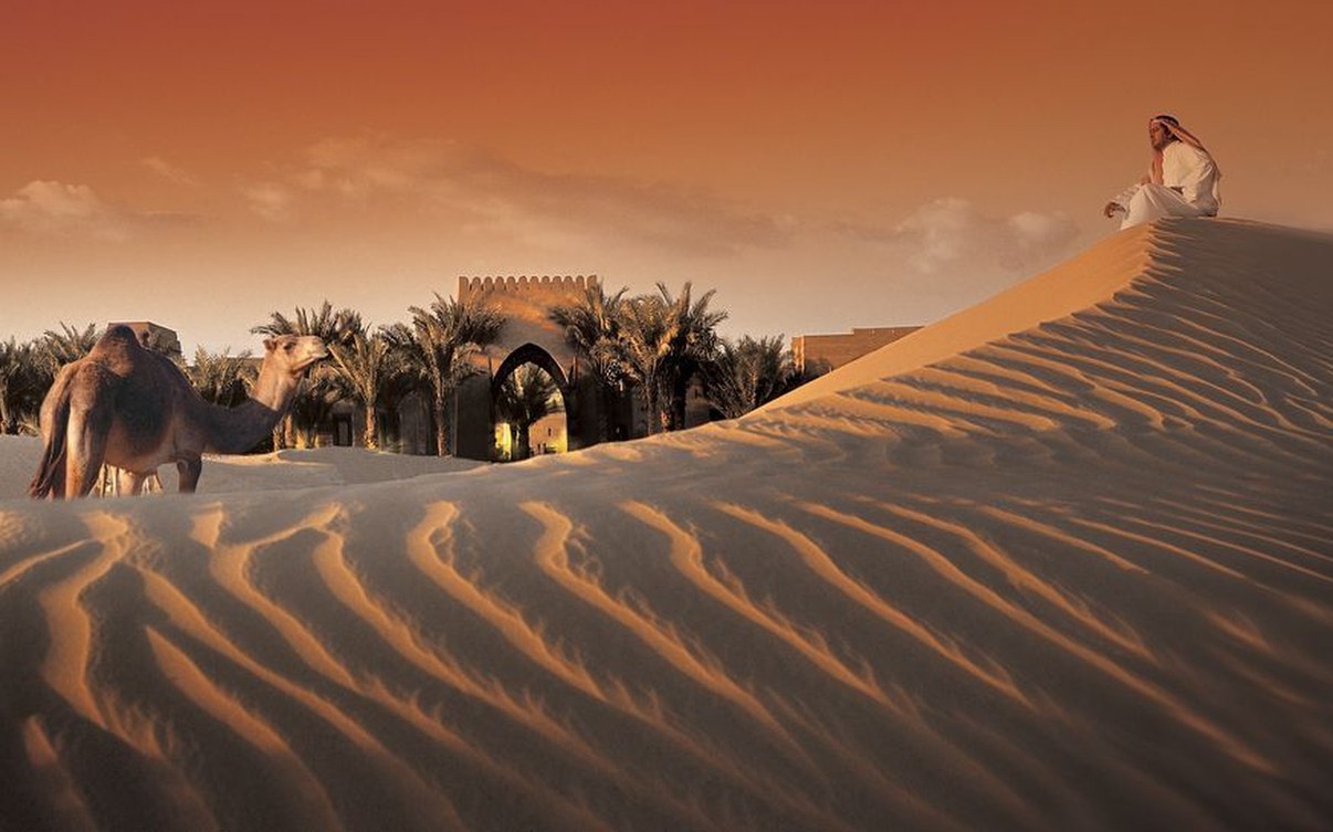 The gate of Bab Al Shams beyond the dunes
