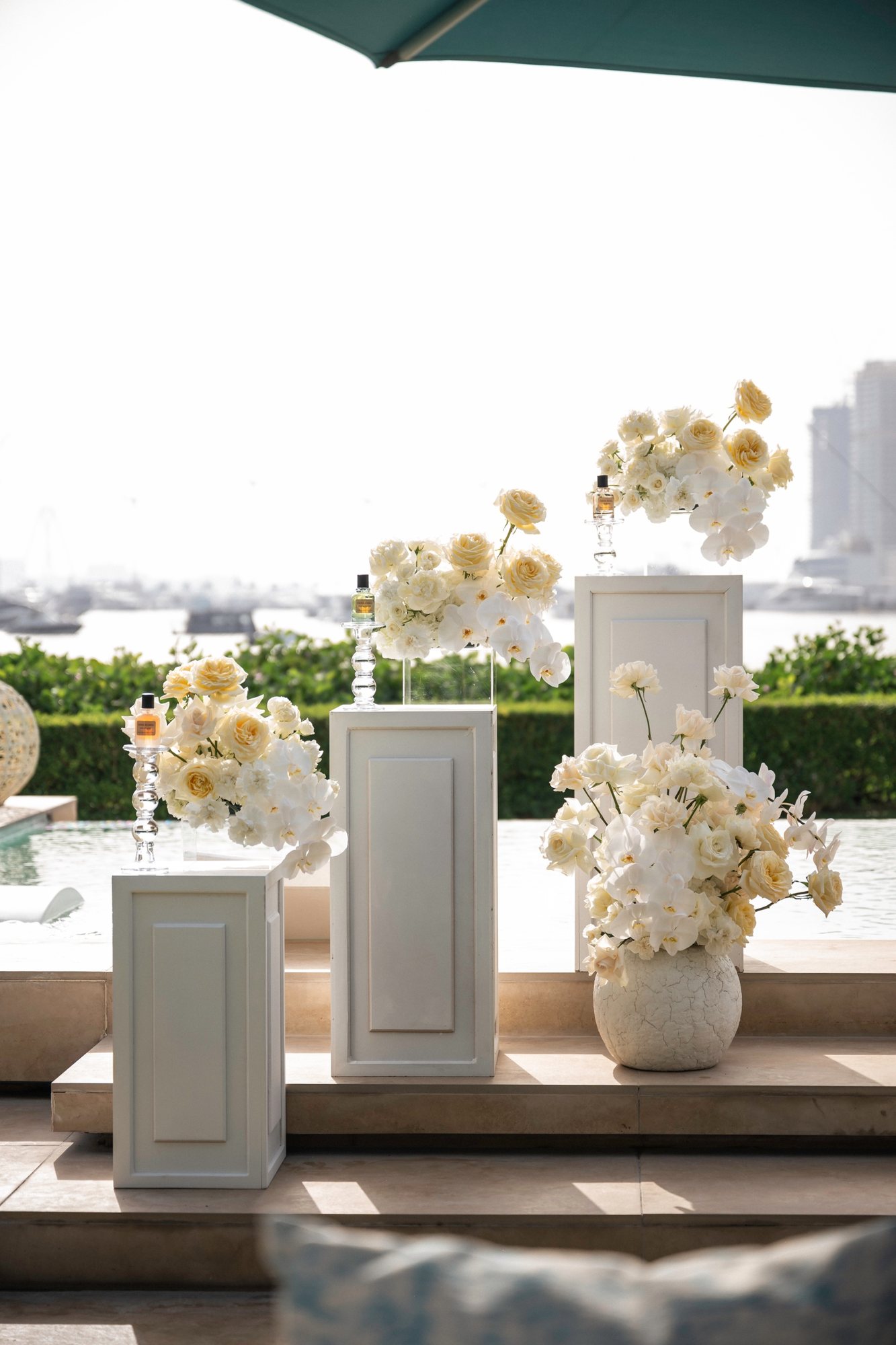 Bottles on crystal plinths, the marina beyond